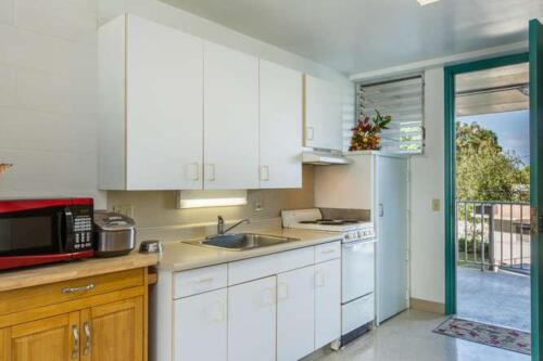 A kitchen with a microwave and refrigerator.